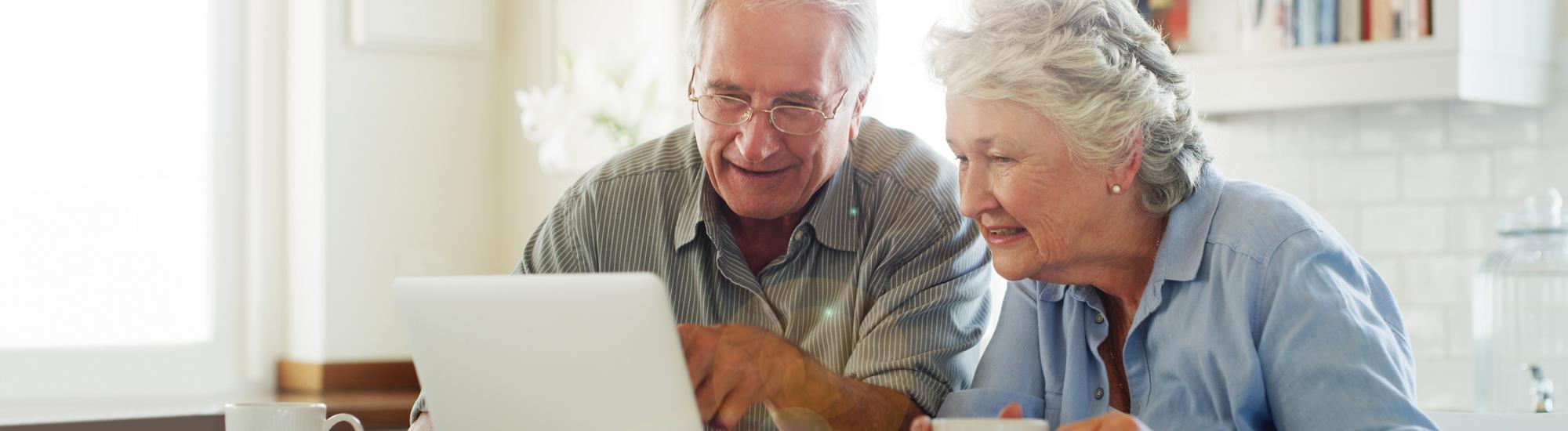 image of senior couple looking at labtop