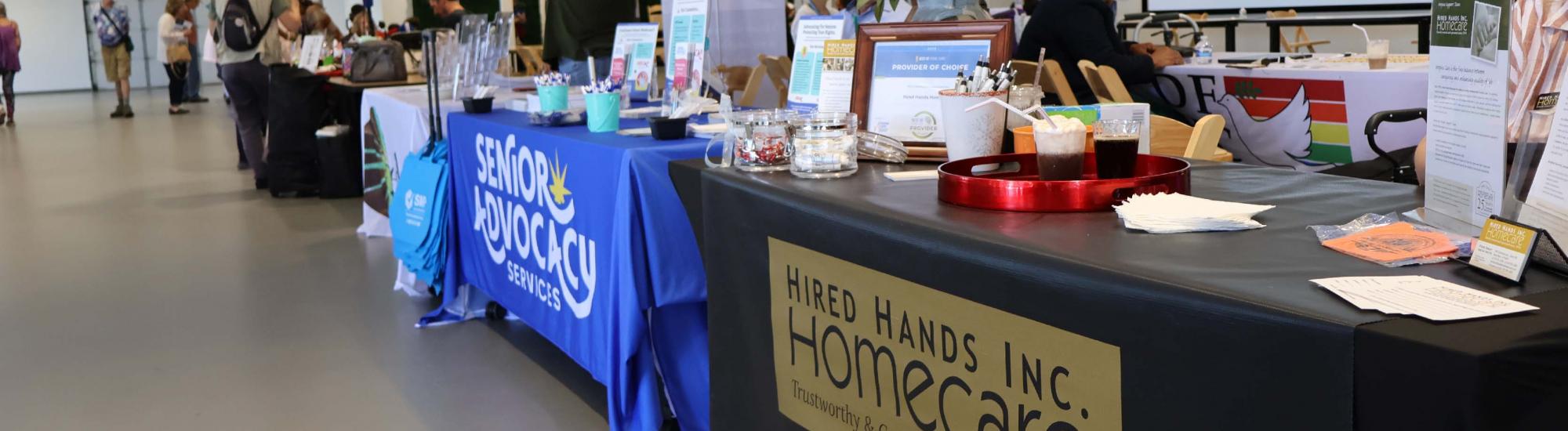 Photo of a disability expo exhibitor tables.